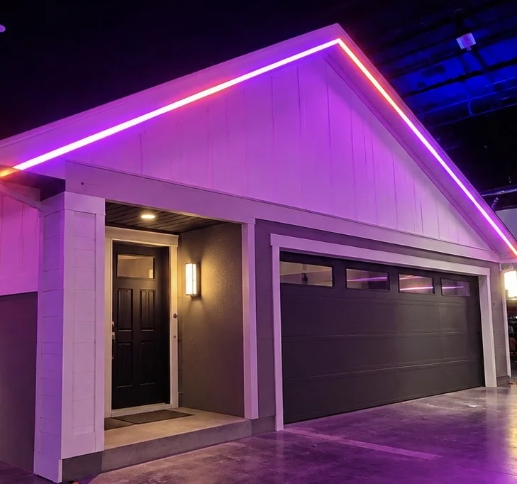 A garage gable with a glowing pink and purple light line along the roofline.