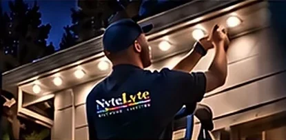 A NyteLyte technician servicing roofline lights.